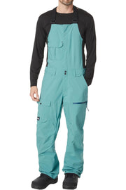 Men's snowboard bib pants in teal with black sleeves and front storage pockets
