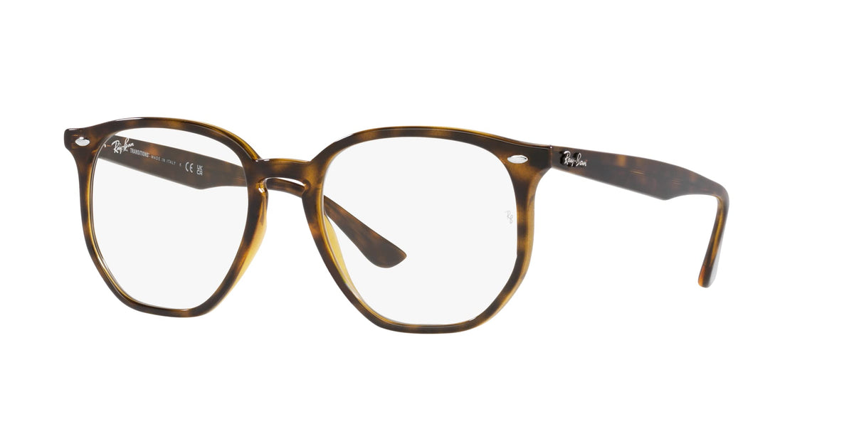Sunglasses with tortoiseshell frame and clear lenses, rounded hexagonal shape.