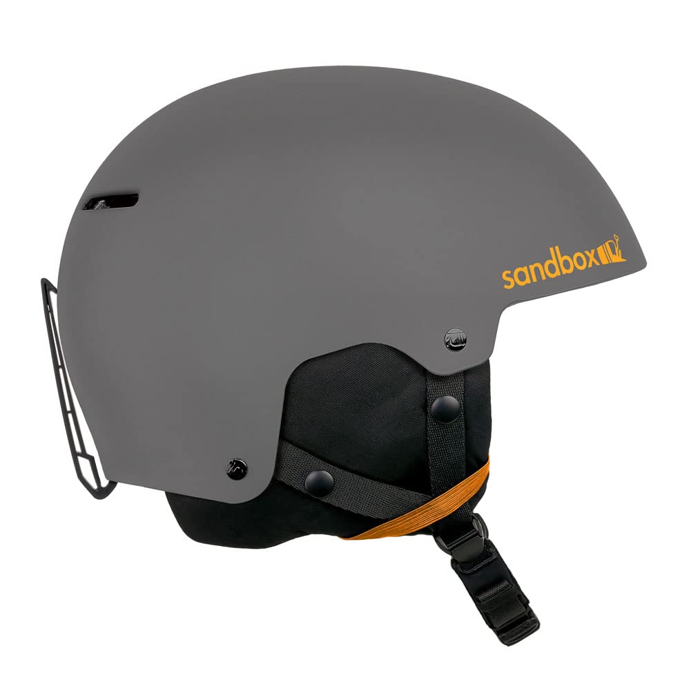 Sandbox snow helmet, dark gray matte shell with orange logo and chin strap.