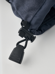 Dark navy powder gauntlet mitten with black leash and toggle for cuff closure