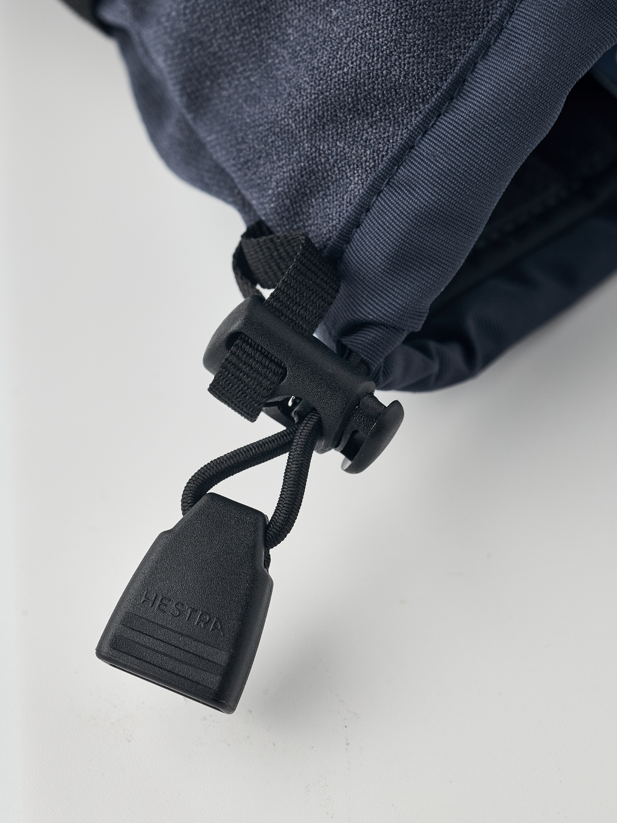 Dark navy powder gauntlet mitten with black leash and toggle for cuff closure