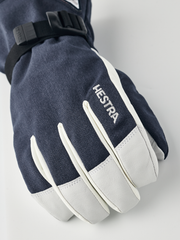 Close-up navy powder gauntlet gloves with white leather palm and thumb panel