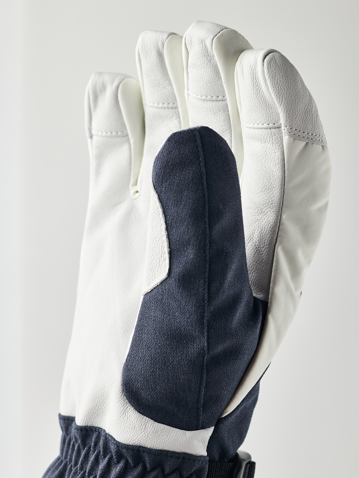 Powder gauntlet gloves in white with dark navy palm patch and elastic cuff