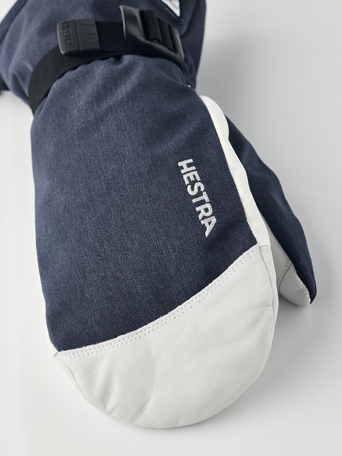 Navy powder gauntlet mittens with white leather palm and Hestra logo on back