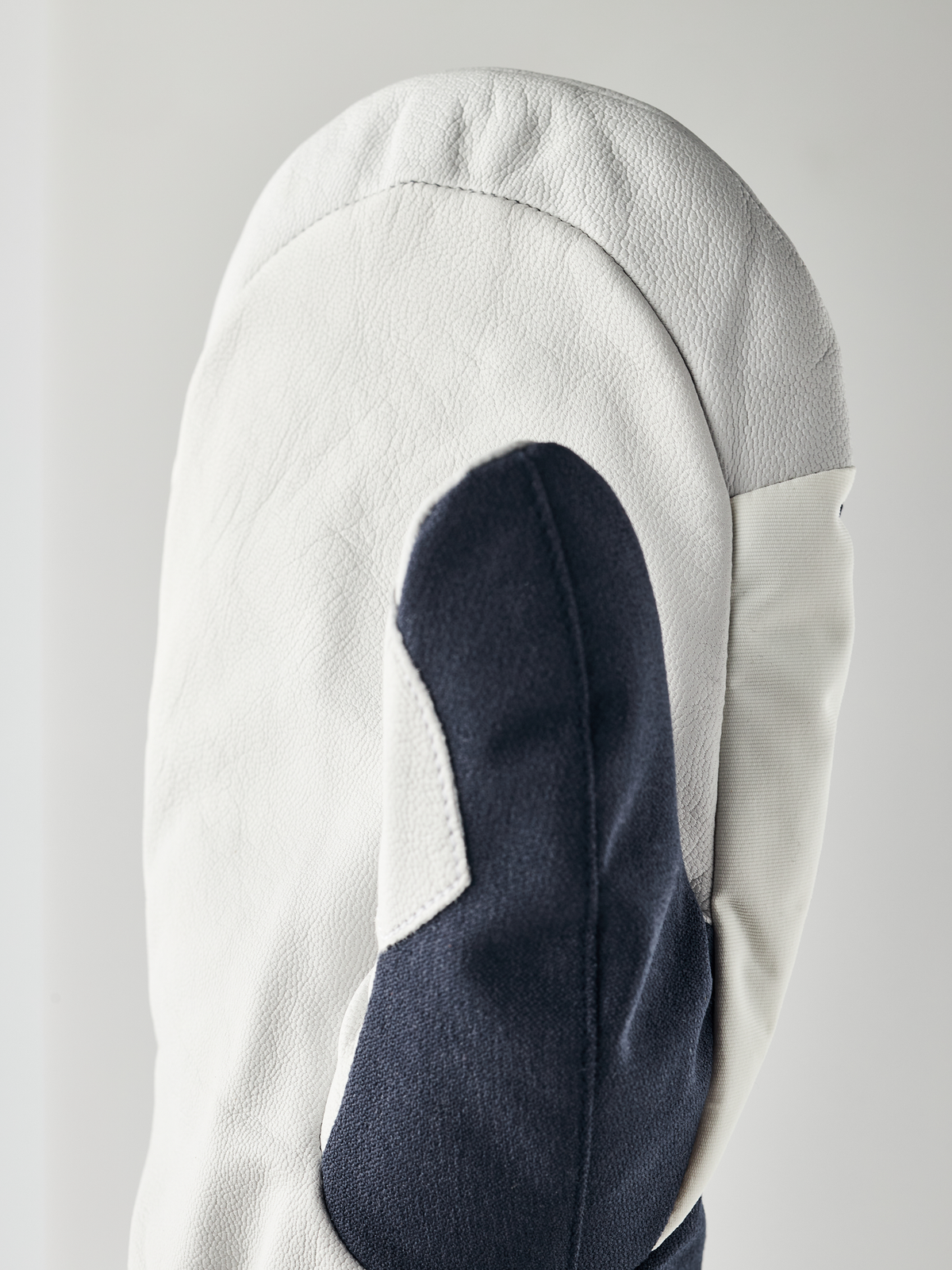 White powder gauntlet mitten with navy interior thumb panel and smooth leather finish