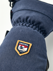 Navy mountain mitten with raised HESTRA patch on the cuff
