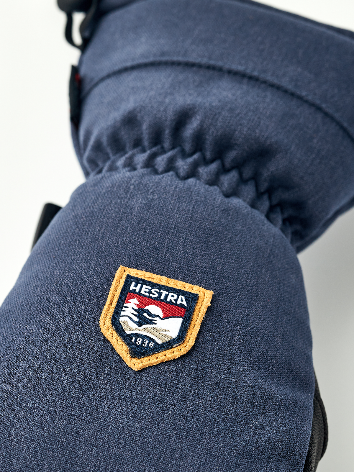 Navy mountain mitten with raised HESTRA patch on the cuff