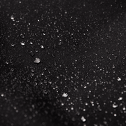 Dark fabric surface with water droplets, water-resistant finish