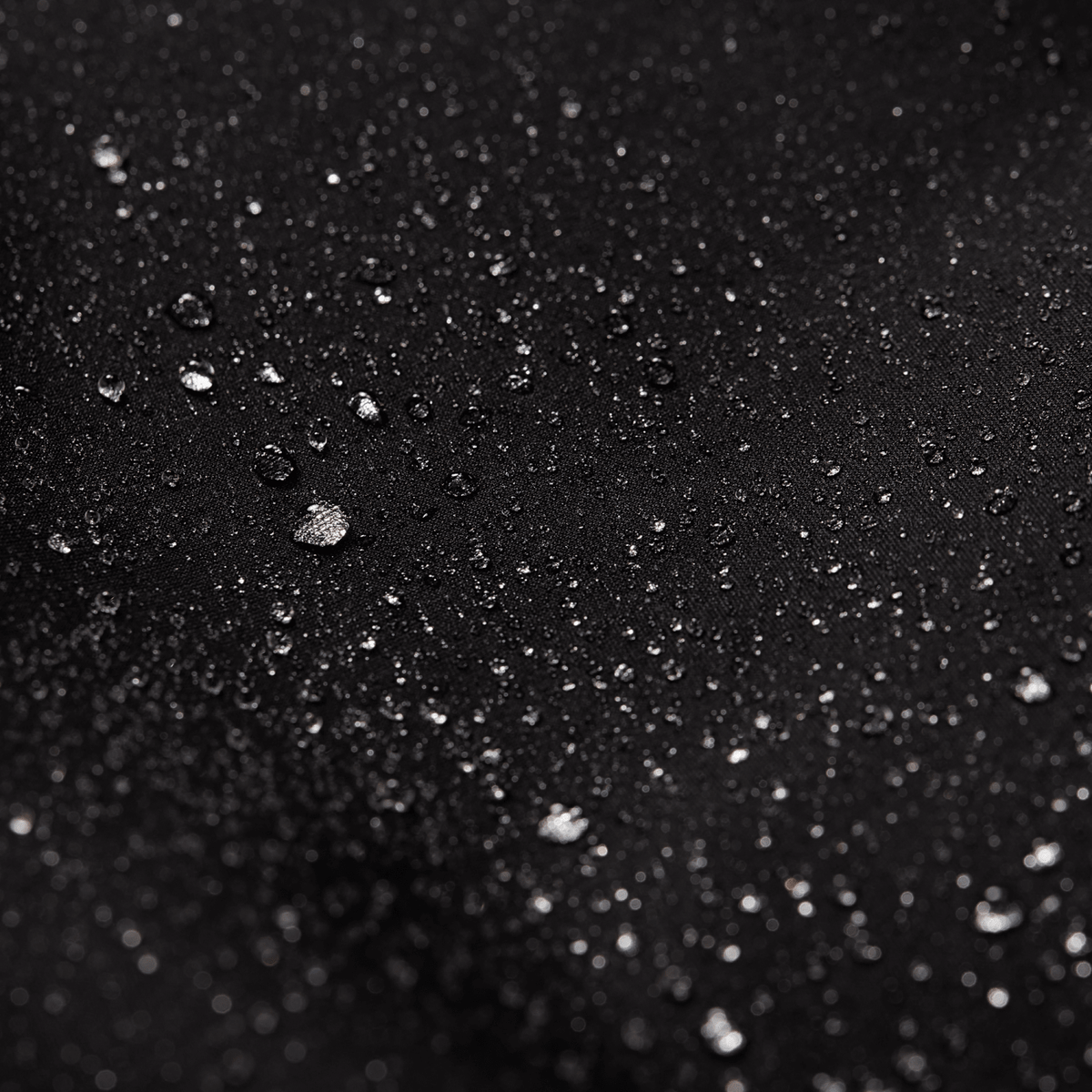 Dark fabric surface with water droplets, water-resistant finish