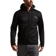 Black zip-front hooded jacket on model with chest logo and side pockets