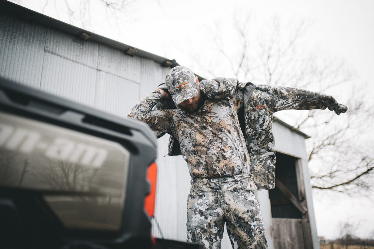 Traverse hoodie in pixel camouflage with hood and full-zip, worn outdoors