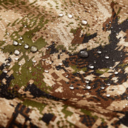 Camouflage hoodie fabric close-up with water droplets on textured pattern