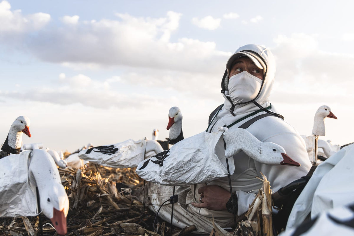 White hooded zip hoodie on a person in a hunting field setting