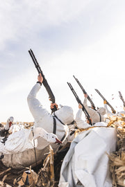 White hooded zip hoodie on a person among hunted birds
