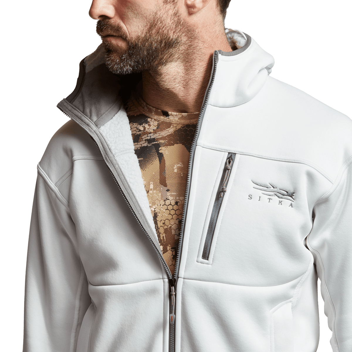 White zip hoodie worn open, showing inner camo fabric at neckline