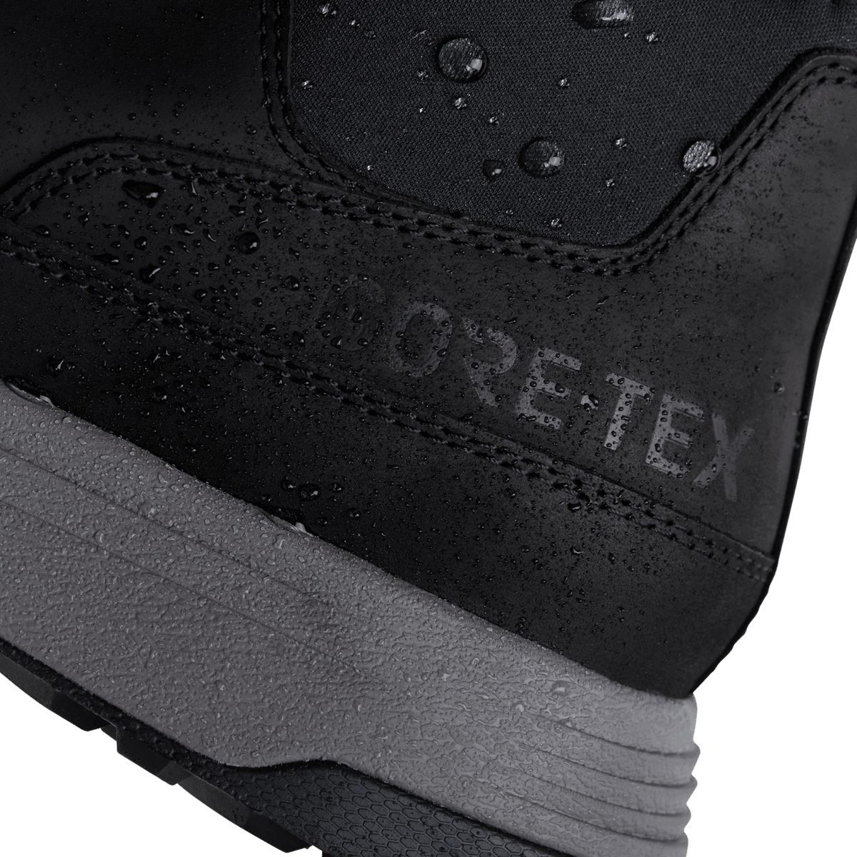 Black waterproof-style ankle boot upper with textured seam and GORE-TEX logo