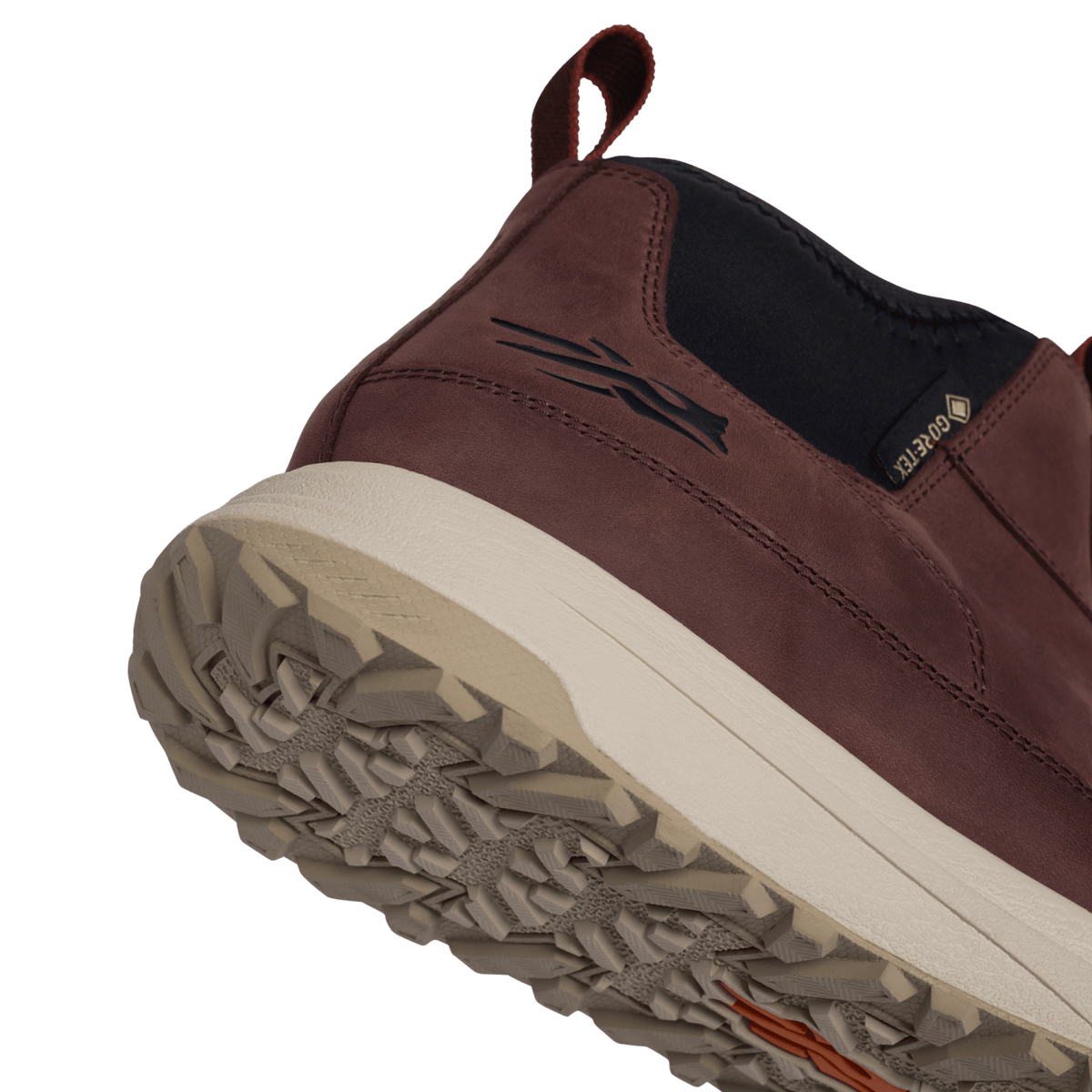 Burgundy suede hiking boot toe and side panel with black trim and treaded outsole