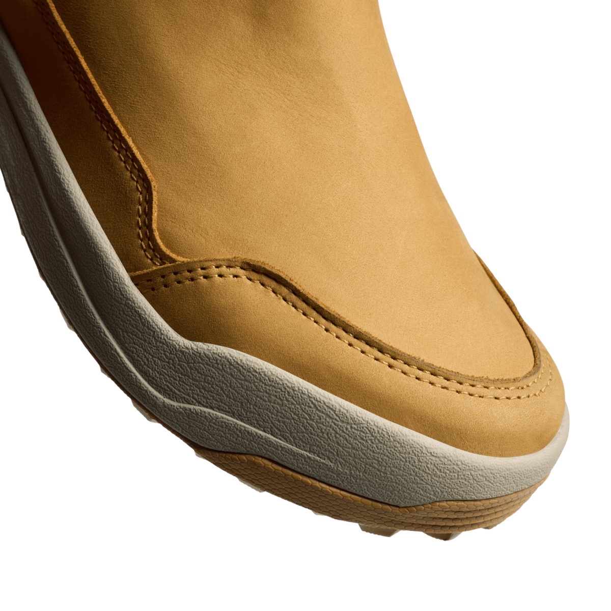 Tan suede boot toe and side seam with contrast stitching and grippy textured sole