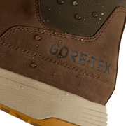 Brown suede ankle boot close-up with GORE-TEX logo and water-bead texture