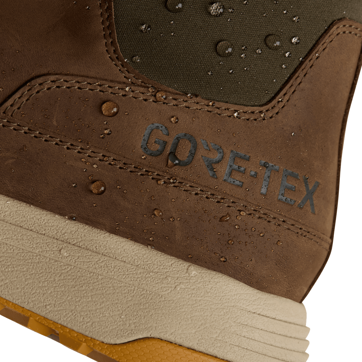 Brown suede ankle boot close-up with GORE-TEX logo and water-bead texture