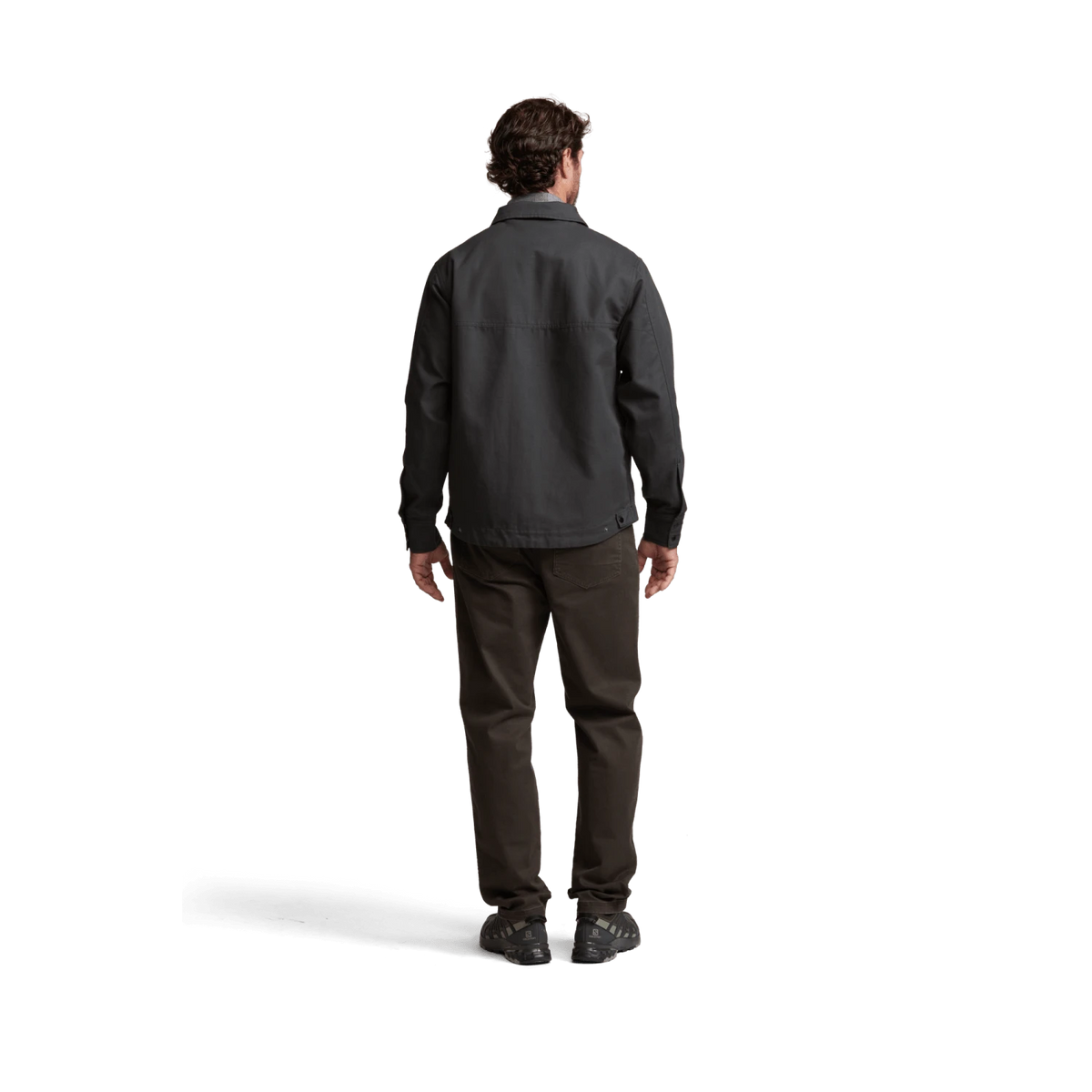 Dark chore coat back view with yoke detail and long sleeves, buttoned front.