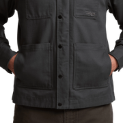 Men’s obsidian-black chore coat close-up of button placket and utility pockets