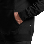 Dark pullover hoodie close-up with kangaroo pocket and drawstring hood