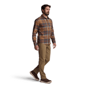 Lightweight flannel shirt in brown and rust plaid with button-front closure; model wearing tan pants.