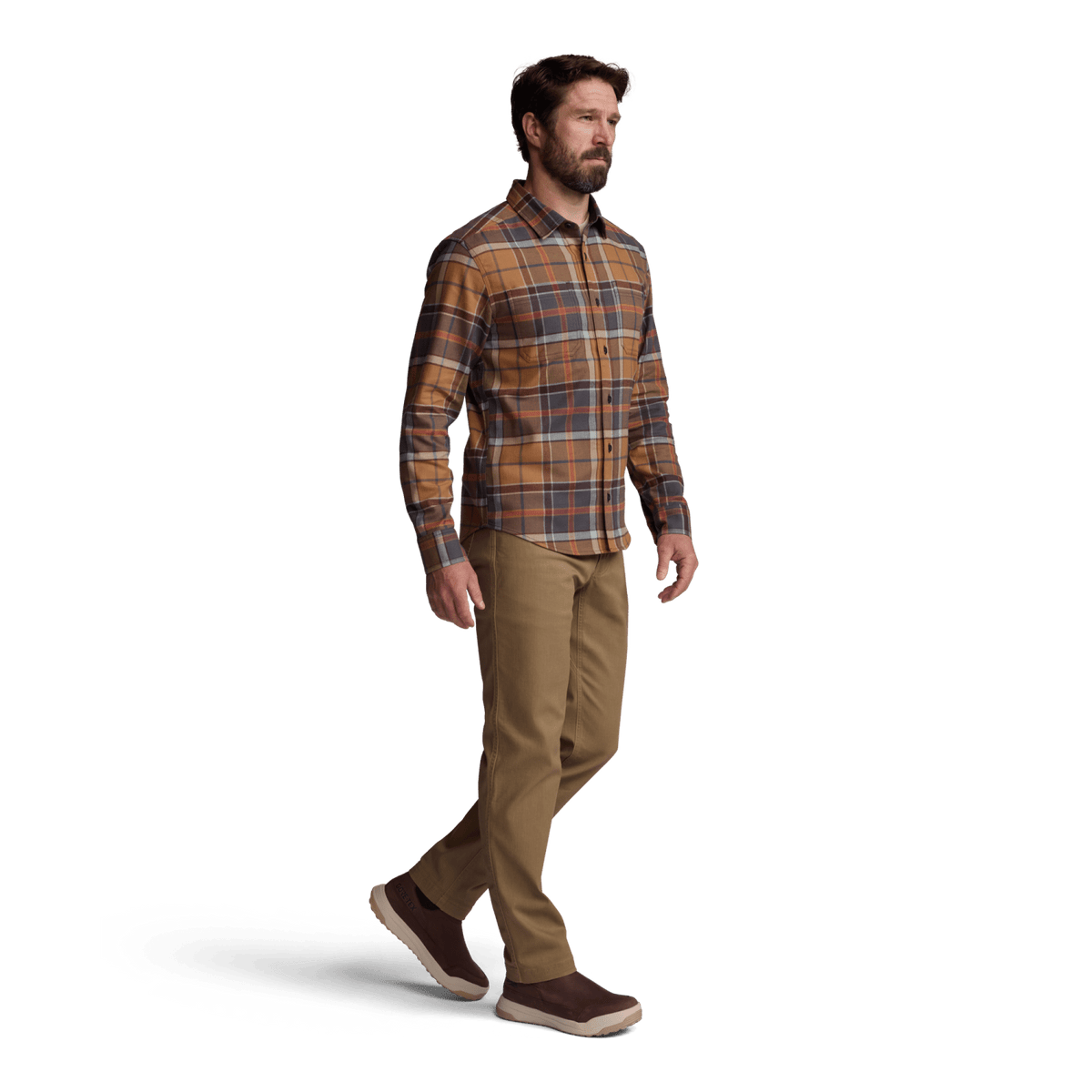 Lightweight flannel shirt in brown and rust plaid with button-front closure; model wearing tan pants.