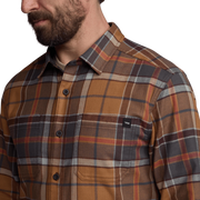 Close-up of lightweight flannel plaid shirt in brown, tan, and gray with chest pocket