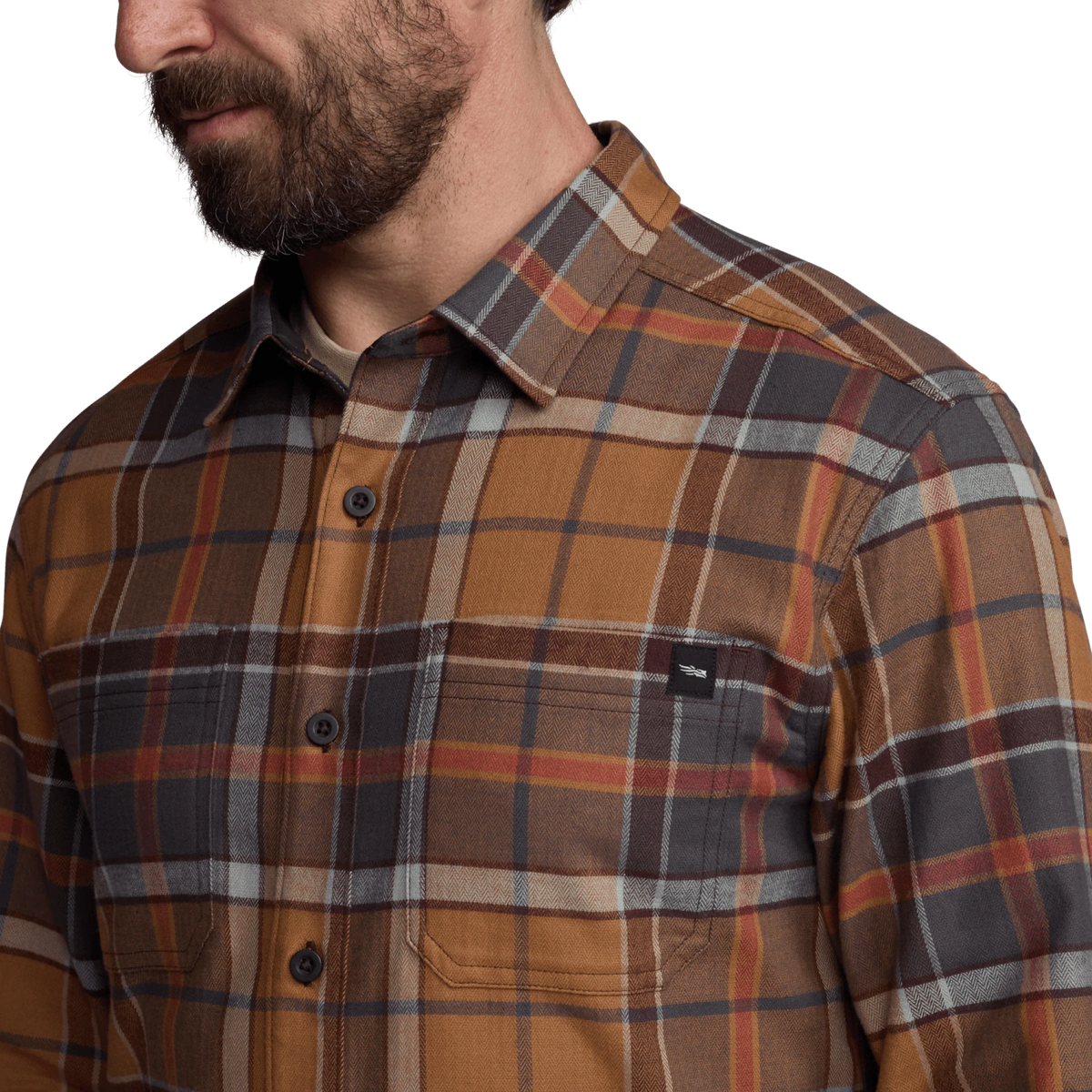 Close-up of lightweight flannel plaid shirt in brown, tan, and gray with chest pocket