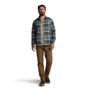 Man wearing blue plaid lightweight flannel button-up with tan pants