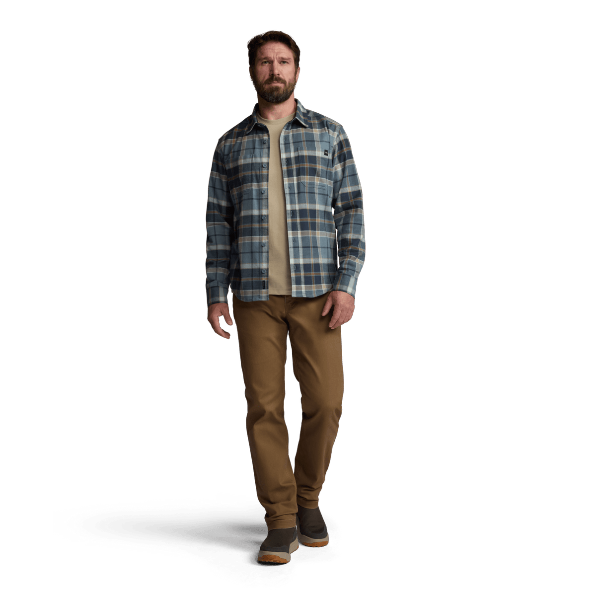 Man wearing blue plaid lightweight flannel button-up with tan pants