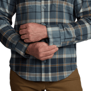 Lightweight flannel shirt cuff and placket in blue plaid, buttoned sleeve detail