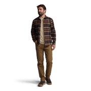 Men's plaid flannel button-up shirt worn casually with long sleeves and chest pocket