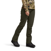 Dark olive tactical pants with side cargo pockets, worn with trail shoes