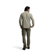 Back view of light beige long-sleeve button-up shirt on a model