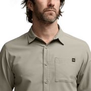 Light beige long-sleeve button-up shirt close-up with chest pocket and collar