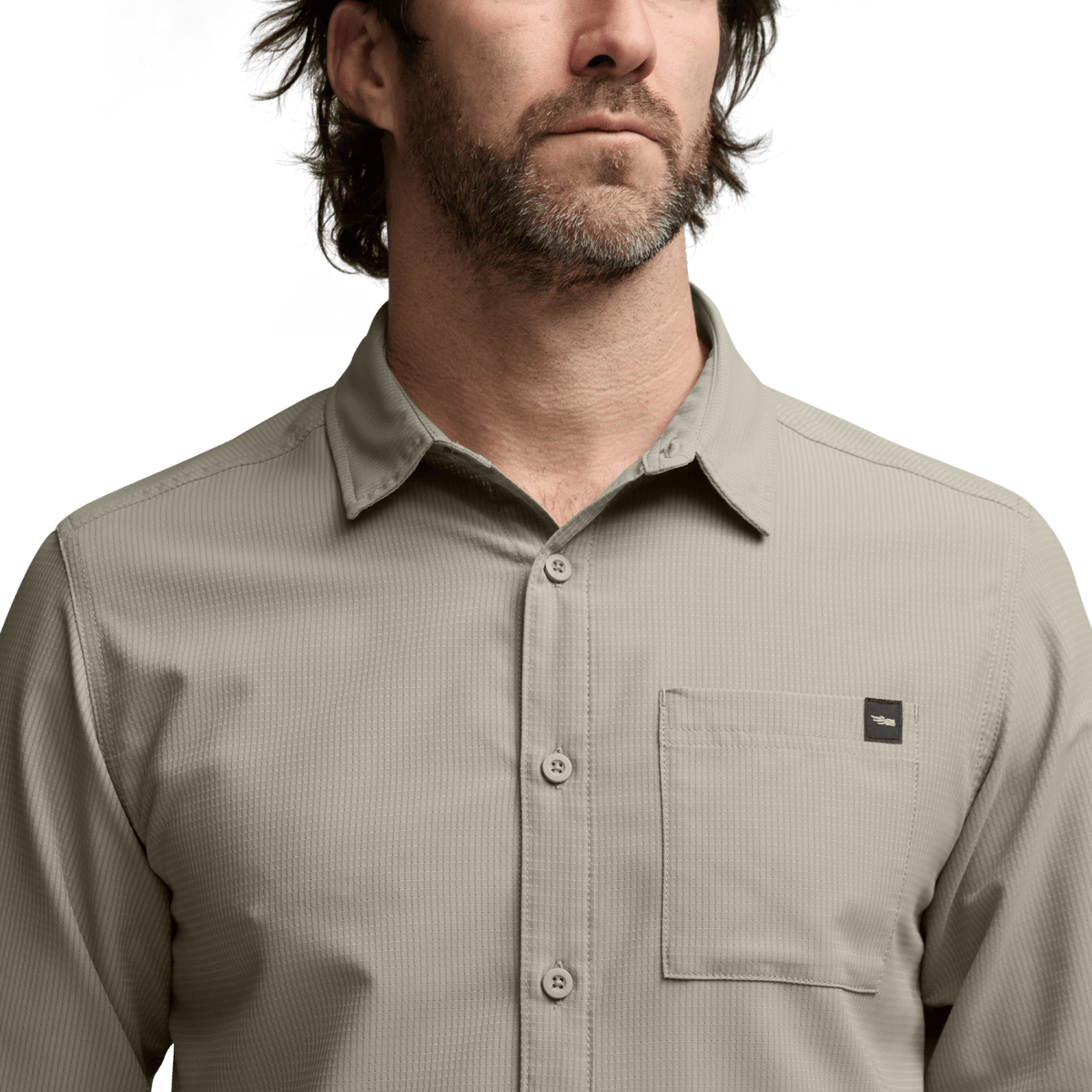 Light beige long-sleeve button-up shirt close-up with chest pocket and collar