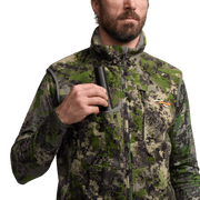 Green camo zip vest with high collar, chest pocket, and zipper area strap