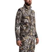 Camouflage vest with high collar and full-zip front over long-sleeve base layer