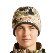 Women’s camouflage beanie worn by model, brown and tan pixel print with black cuff