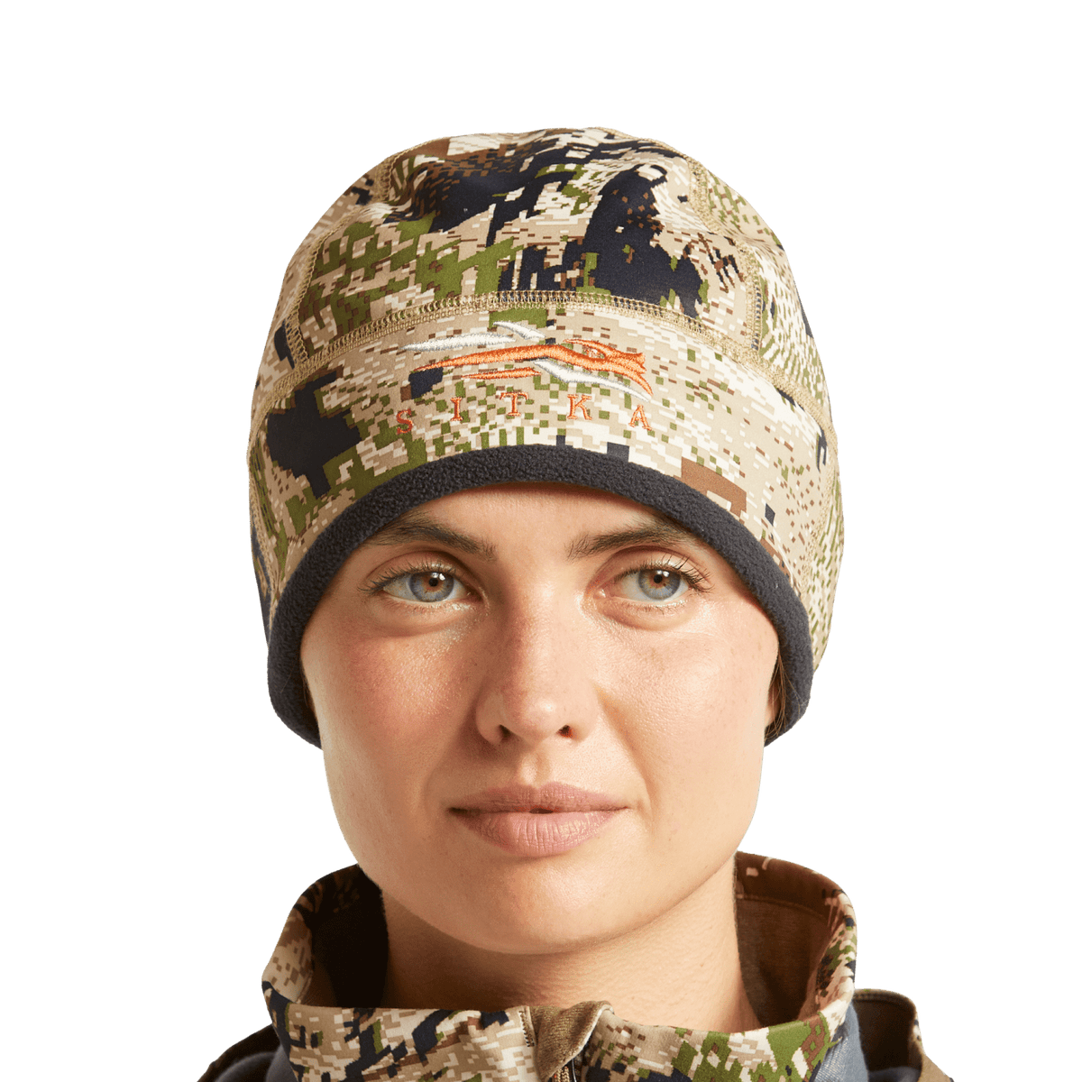 Women’s camouflage beanie worn by model, brown and tan pixel print with black cuff