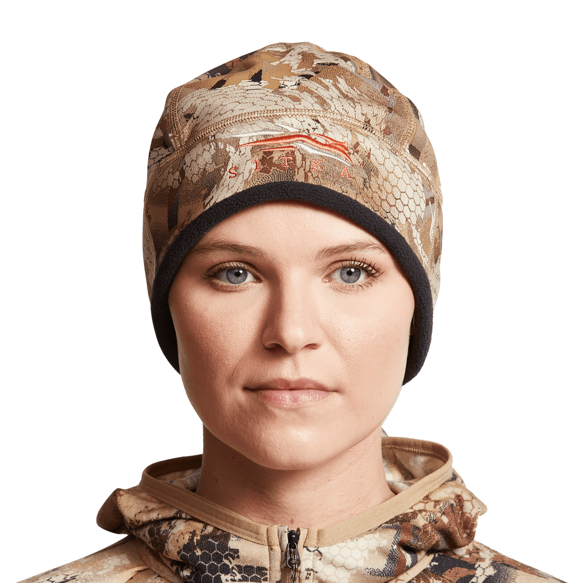 Women’s camouflage beanie worn by model, brown and tan animal-print with black cuff
