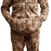 Worn camo insulated hand muff attached at the front pouch