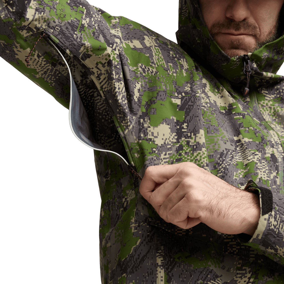 Camo jacket close-up with front zipper area and hand pulling fabric at chest