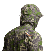 Green camo hooded jacket with side zipper pocket, angled view on model