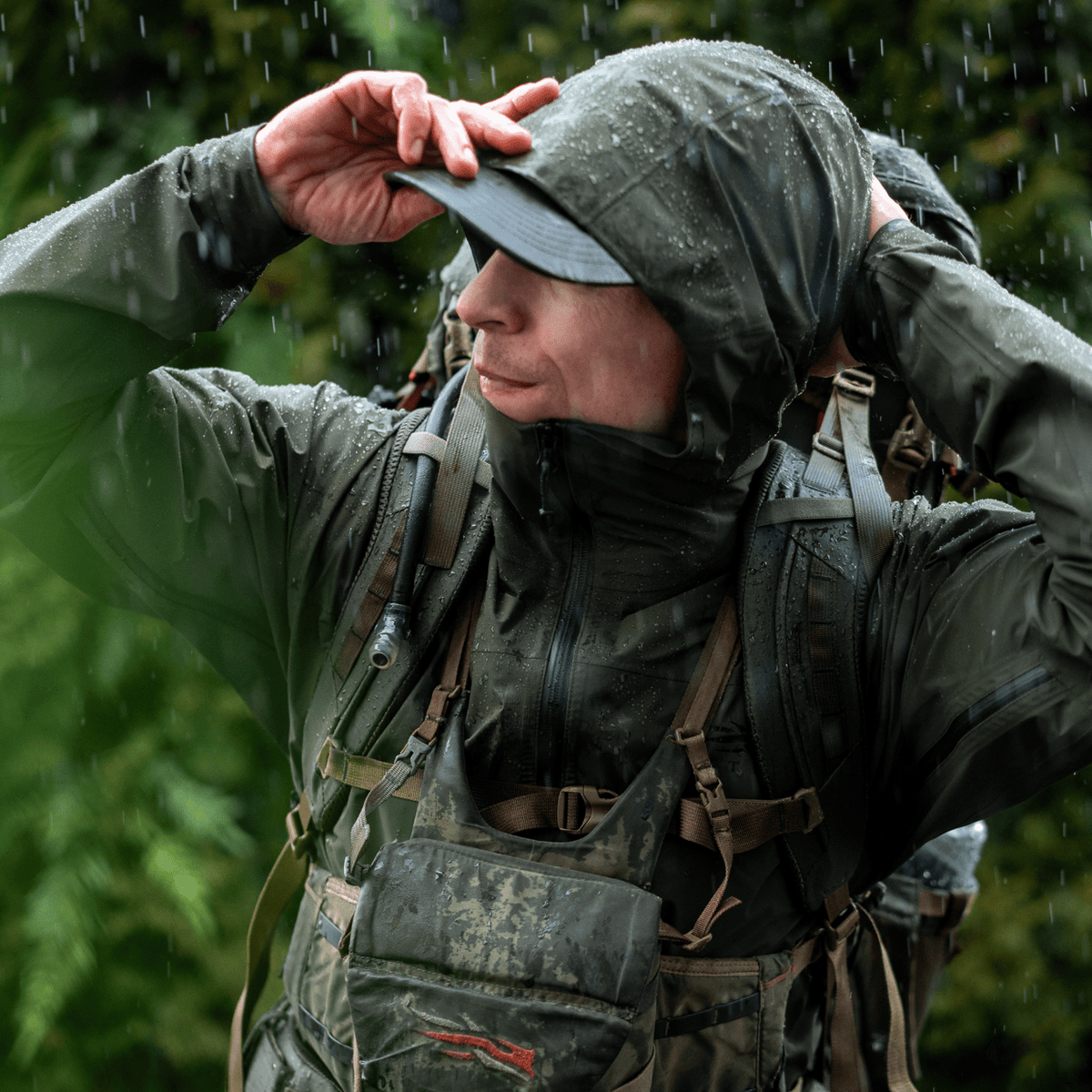 Dark green hooded jacket with full-zip front, elastic cuffs, and adjustable hem
