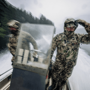 Camouflage hooded jacket worn outdoors near boat gear