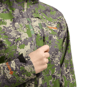 Women’s pixel camouflage jacket with front zipper and hand holding the collar area